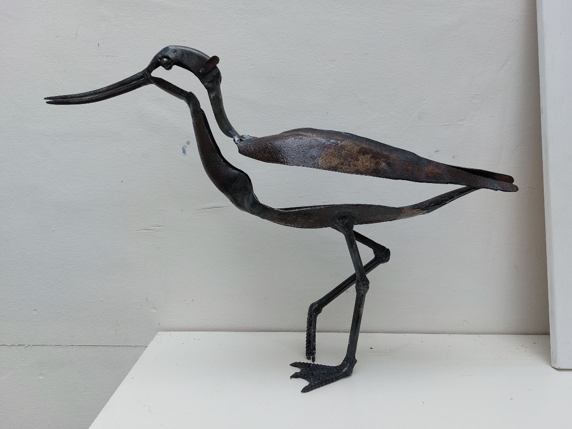 A wader sculpture on white box